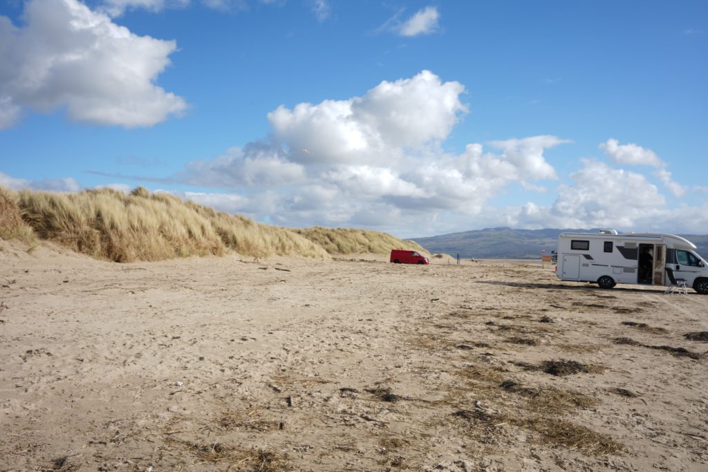 Black Rock Sands beach in Snowdonia North Wales with sand dunes, blue sky, and coastal scenery