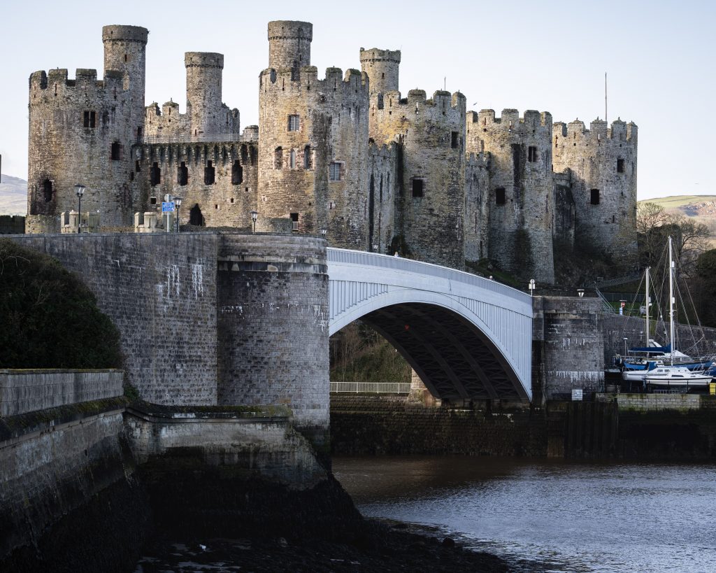 Conwy Castle in Snowdonia North Wales beside the river with historic stone towers and bridge in the foreground