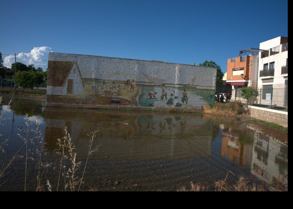Traditional rice farming mural reflected in water near Albufera, Valencia, Spain