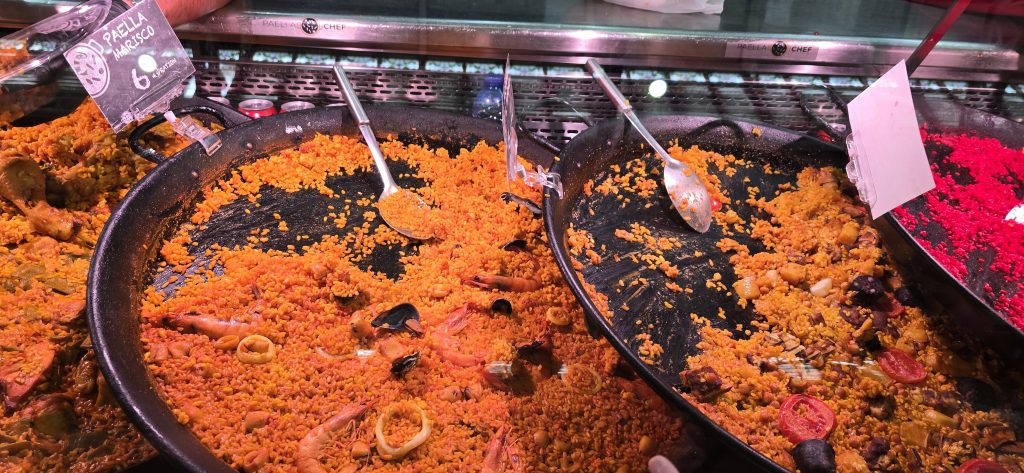 Fresh paella displayed inside Mercado Central in Valencia, Spain