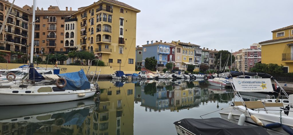 Colourful waterfront buildings and boats at Port Saplaya near Valencia, Spain