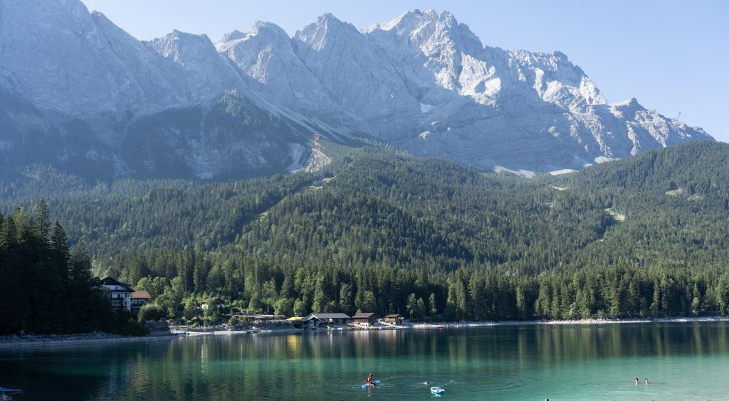 Lake Eibsee reflecting the forest and mountains beneath the Zugspitze in Bavaria