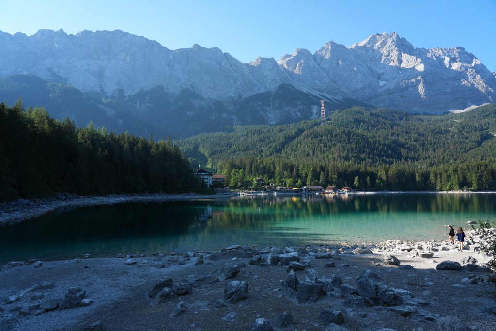 Rocky shore and turquoise water of Lake Eibsee beneath the Bavarian mountains