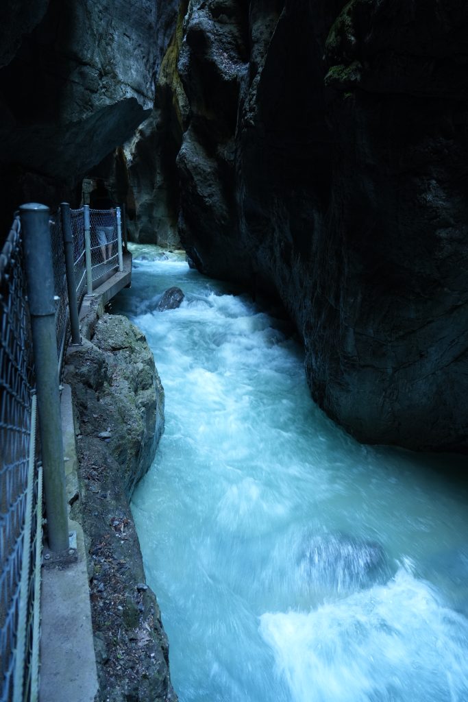 White water rushing through the narrow rock walls of Partnachklamm Gorge