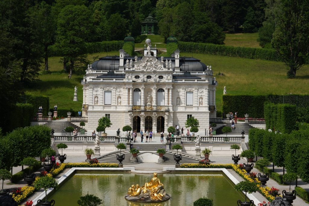 Linderhof Palace seen across its formal gardens and fountain