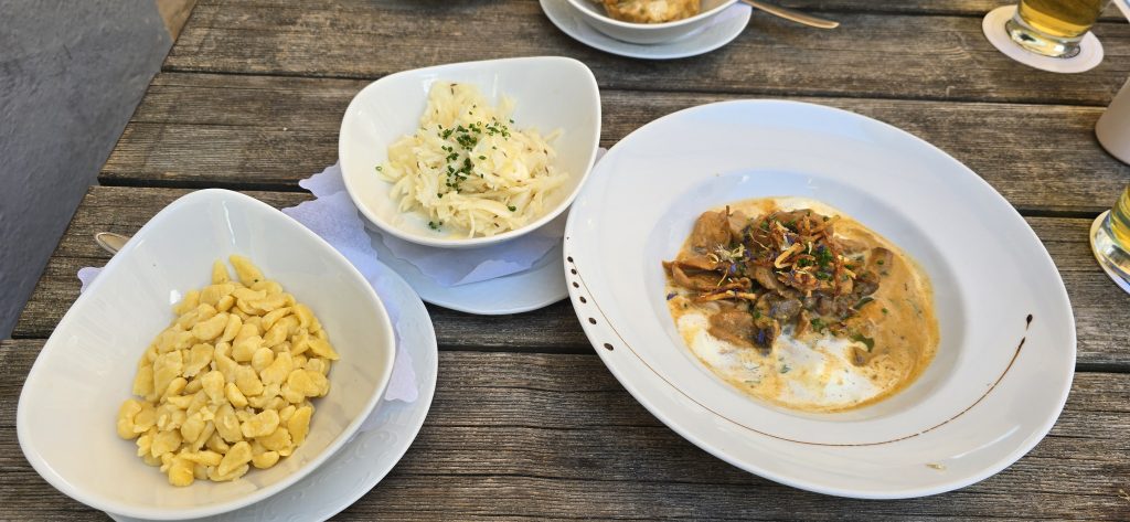 Plates of food served at an outdoor restaurant table during our Bavaria trip